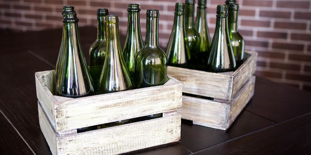 olive oil bottles on wooden table with Mediterranean background