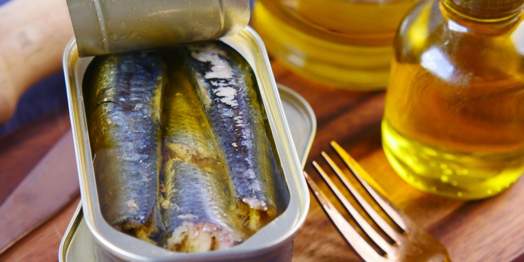 a tin of sardines sitting on top of a wooden table